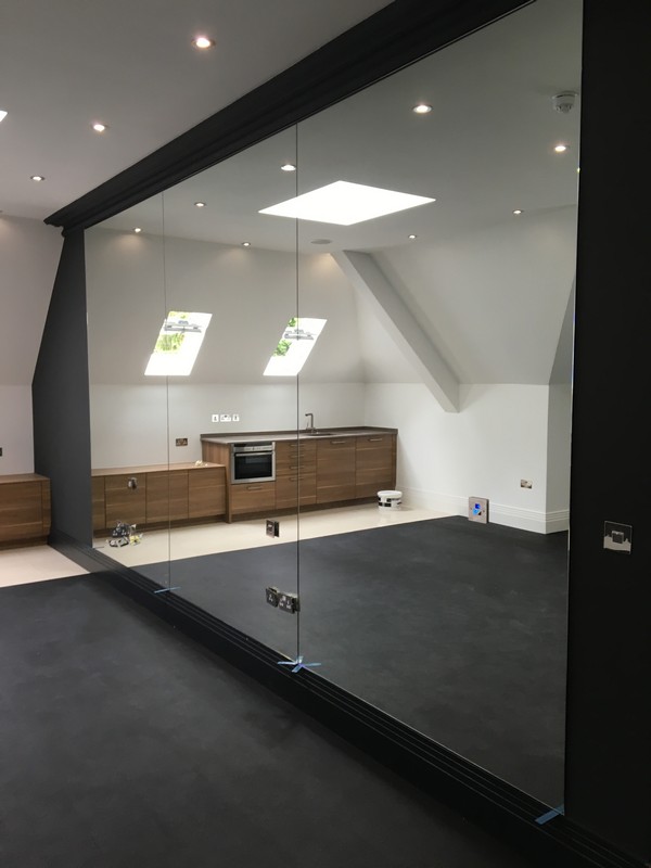 Frameless glass partition in loft conversion by Bloomsbury glaziers