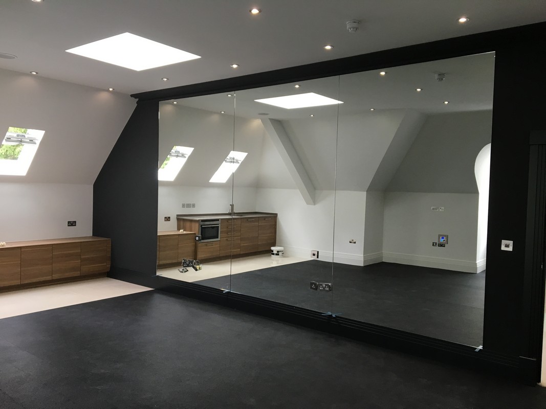 Frameless glass wall dividing loft conversion in Bloomsbury