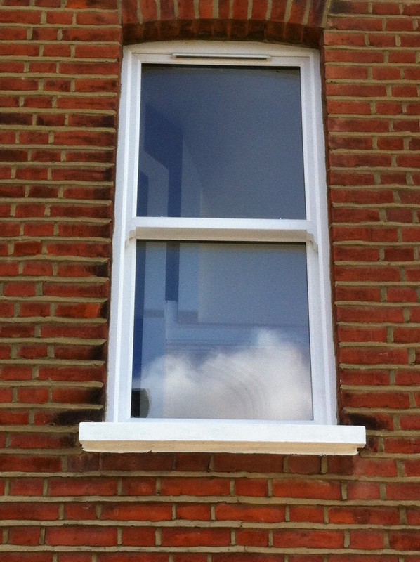 uPVC sash window on Victorian red brick house in Bloomsbury